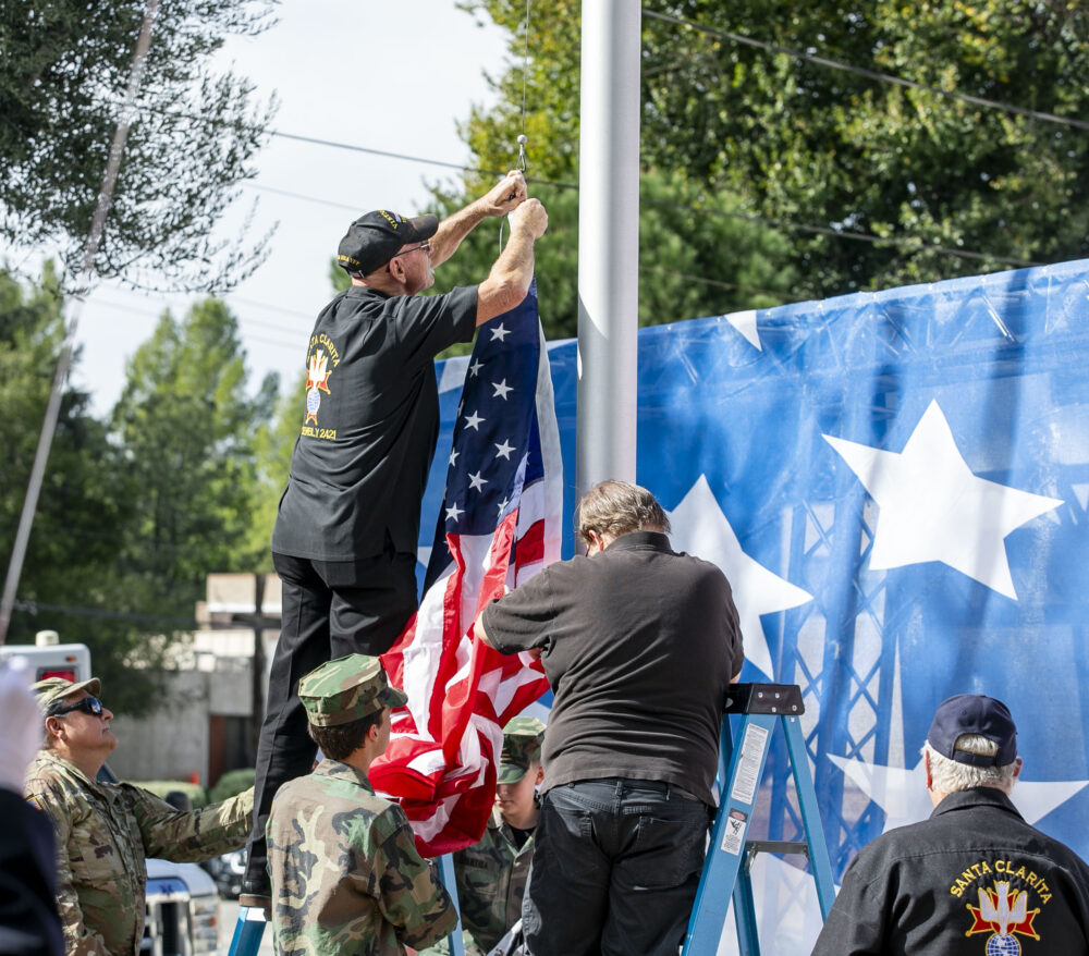 Knights of Columbus Santa Clarita Assembly, Vietnam Veterans of America, Chapter 355, and Santa Clarita Valley Young Marines change the flags during the 19th annual Santa Clarita Veterans Day Ceremony at Veterans Historical Plaza on Tuesday, Nov. 11, 2025. Habeba Mostafa/ The Signal