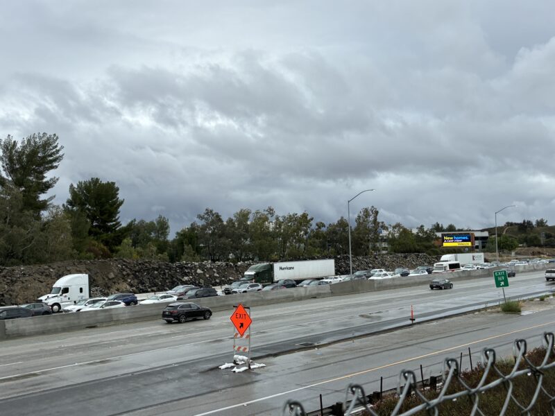 Traffic delays after a call about a big rig leaking diesel due to a white SUV  that hydroplaned and hit it on Interstate 5 northbound Magic Mountain Parkway. Kamryn Martell/The Signal