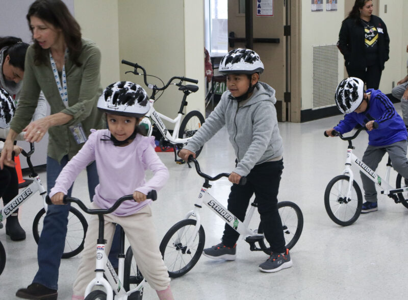 Children ride bikes around a small bicycle track at the "All Kids Bike" event at Newhall Elementary School in Newhall, Calif., Monday, Nov. 17, 2025. Kamryn Martell/The Signal