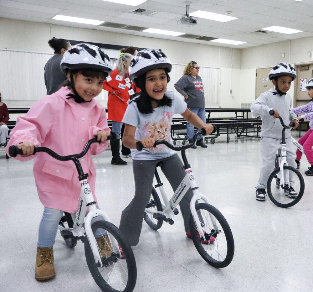Children smile while they ride bicycles at the "All Kids Bike" event at Newhall Elementary School in Newhall, Calif., Monday, Nov. 17, 2025. Kamryn Martell/The Signal