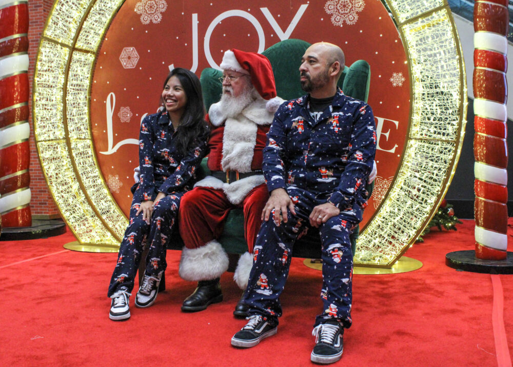 Santa takes a photo with Mary Lou Cortez, left, and Ricardo Cortez at the Valencia Town Center on Saturday, Nov. 15, 2025. Susan Monaghan/The Signal