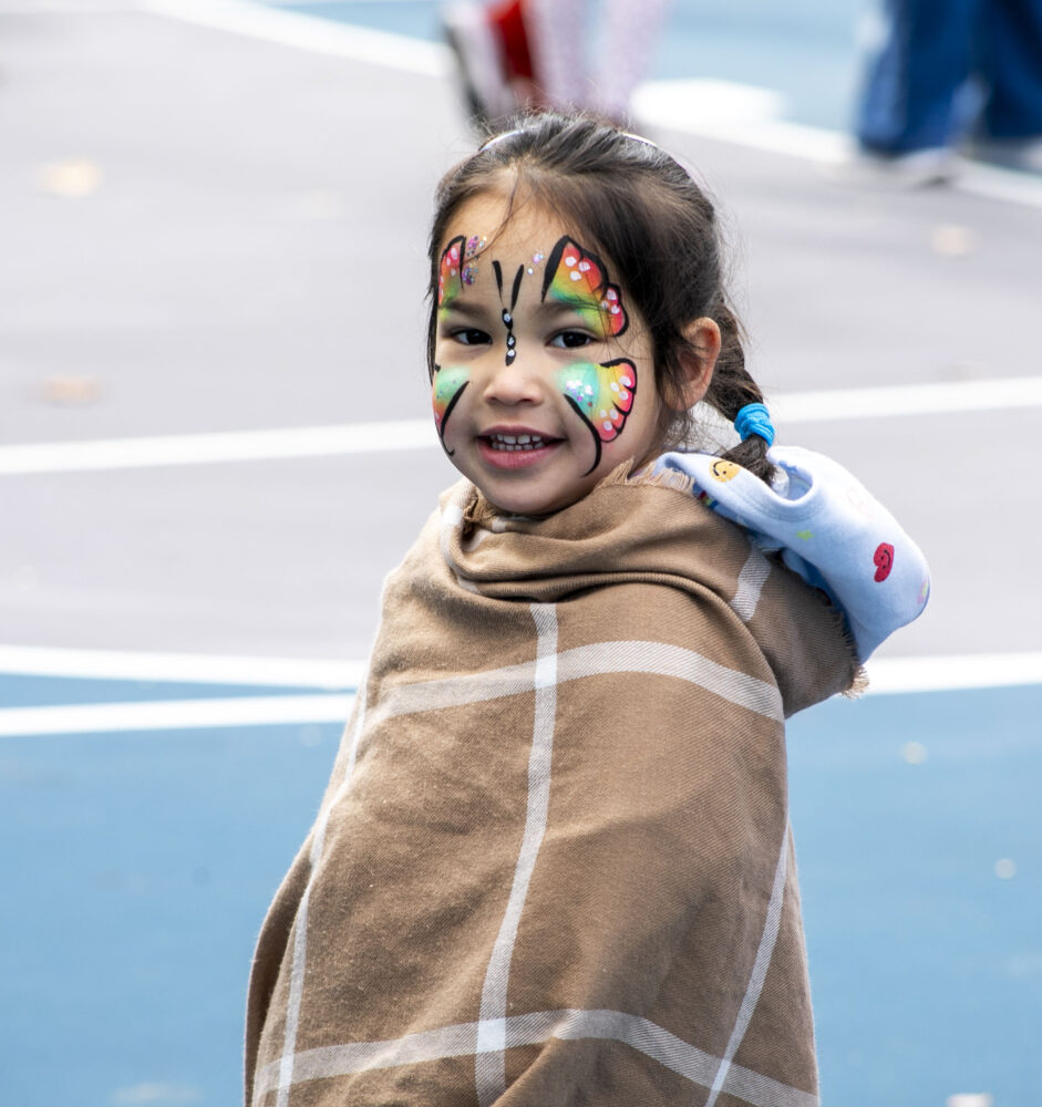 Amelia Mata, 3, received face painting in the shape of a butterfly during the L.A. County Parks Harvest Festival at Dr. Richard Rioux Park on Saturday, Nov. 22, 2025. Habeba Mostafa/ The Signal