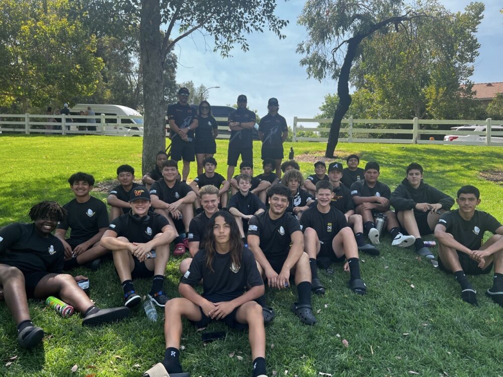 From left: Dave and Erica Corbet, coach Garett Monroe and Tyler Corbet stand behind the Warrior Chiefs. Courtesy Photo/Amanda Telford