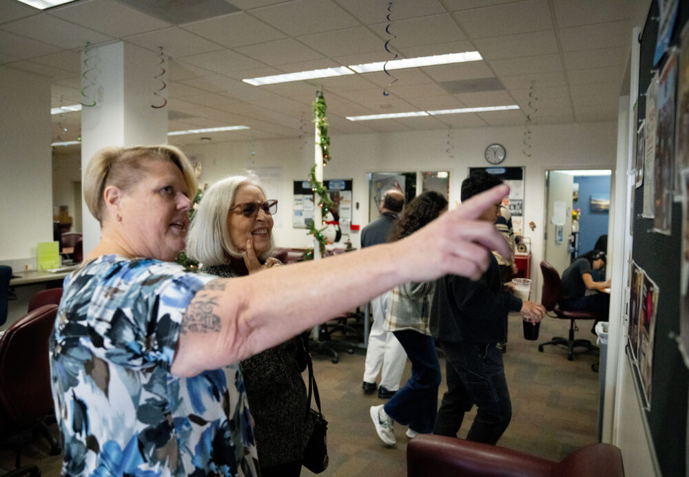MESA Program Director Amy Foote (left) shows COC Trustee Edel Alonso the “MESA Student Highlights” wall during the MESA Program’s 25th anniversary celebration in the Aliso Courtyard of the College of the Canyons campus on Tuesday, Nov. 25, 2025. Katherine Quezada/The Signal