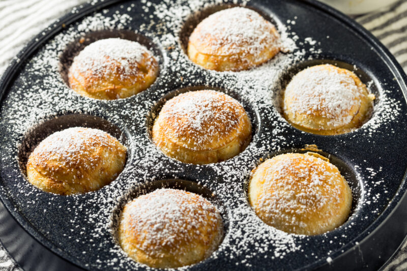 Æbleskiver is a light Danish pancake ball cooked in a cast iron pan at Advent. ©ADOBESTOCK