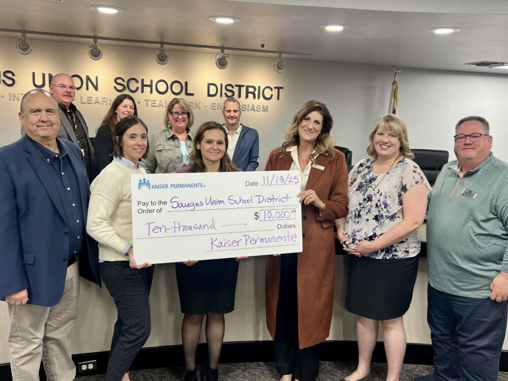 Saugus Union School District board members and Superintendent Colleen Hawkins (back row center) receive a $10,000 grant presented by Kaiser Permanente Community Health Manager Amy Wiese (third from right). Courtesy photo.