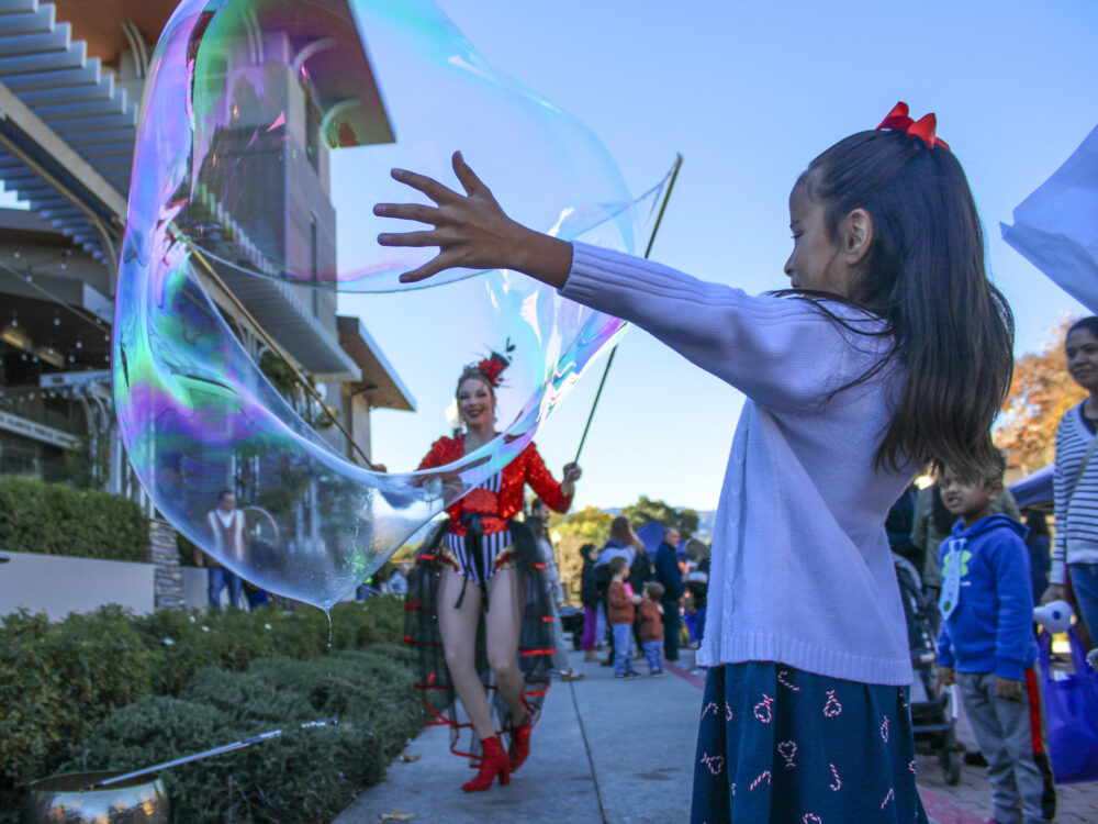 Kids and families enjoy the circus theme of the Family Literacy Festival outside the Old Town Newhall Library on Saturday, Dec. 6, 2025. Susan Monaghan/The Signal
