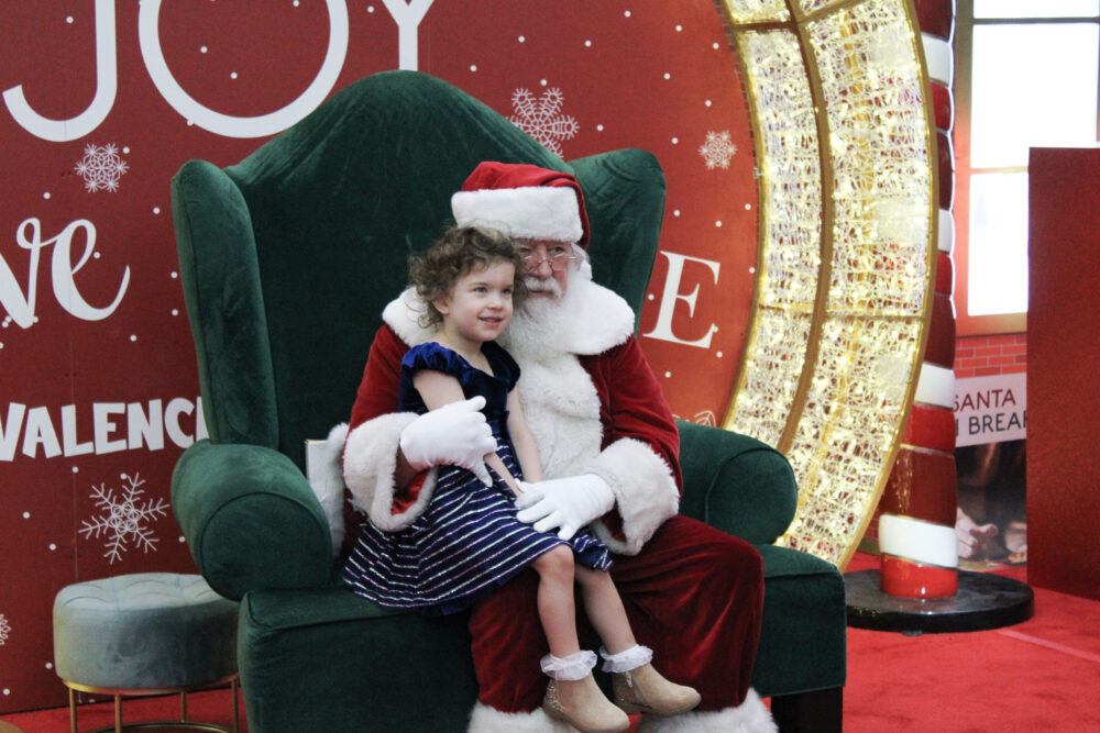 Alyson Werner (L), 3, poses with Santa Clause at the Sensory-Friendly Santa Visits photo event at Westfield Valencia Town Center in Valencia, Sunday, Dec. 7, 2025. Kamryn Martell/The Signal
