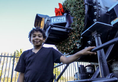 David Addison, 12, stands in front of the Santa Clarita Valley Historical Society's famous Mogul 1629 engine during the nonprofit's Polar Express Experience on Saturday, Dec. 6, 2025. Susan Monaghan/The Signal