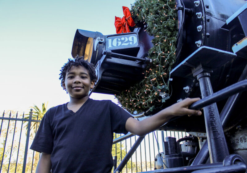 David Addison, 12, stands in front of the Santa Clarita Valley Historical Society's famous Mogul 1629 engine during the nonprofit's Polar Express Experience on Saturday, Dec. 6, 2025. Susan Monaghan/The Signal