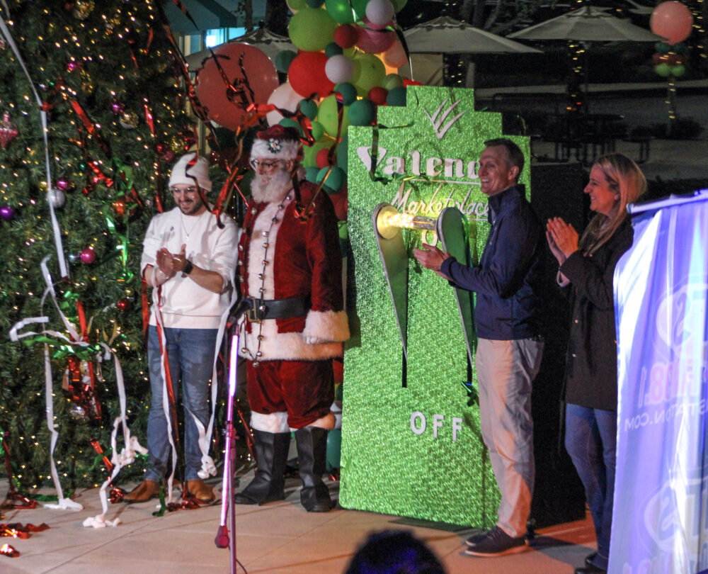Local officials and event organizers applaud after pulling the "switch" to light the Valencia Marketplace tree on Friday, Dec. 5, 2025. Susan Monaghan/The Signal