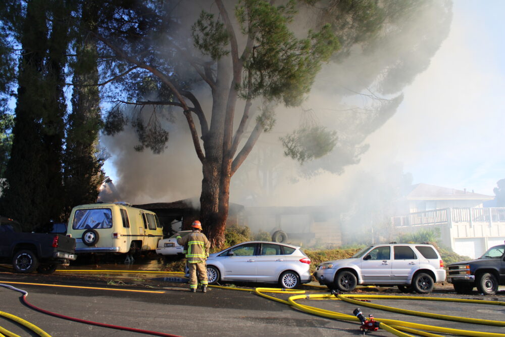 Firefighters work to put out a residential fire on Flower Park Drive in Canyon Country on Saturday, Dec. 13, 2025. Susan Monaghan/The Signal