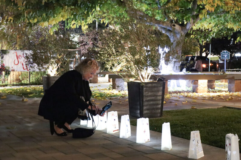 Mary Yancey takes a photo of her son's lantern at the Santa Clarita Valley Chapter of Compassionate Friends 24th annual Candlelight Remembrance Program at BethlehemSCV in Canyon Country, Calif., Sunday, Dec. 14, 2025. Kamryn Martell/The Signal