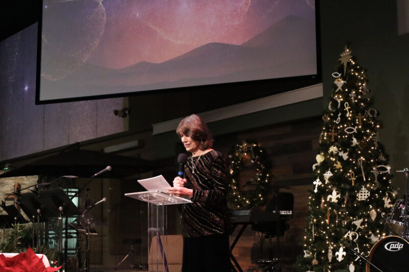 Diane Briones welcomes the audience to the evening at the Santa Clarita Valley Chapter of Compassionate Friends 24th annual Candlelight Remembrance Program at BethlehemSCV in Canyon Country, Calif., Sunday, Dec. 14, 2025. Kamryn Martell/The Signal
