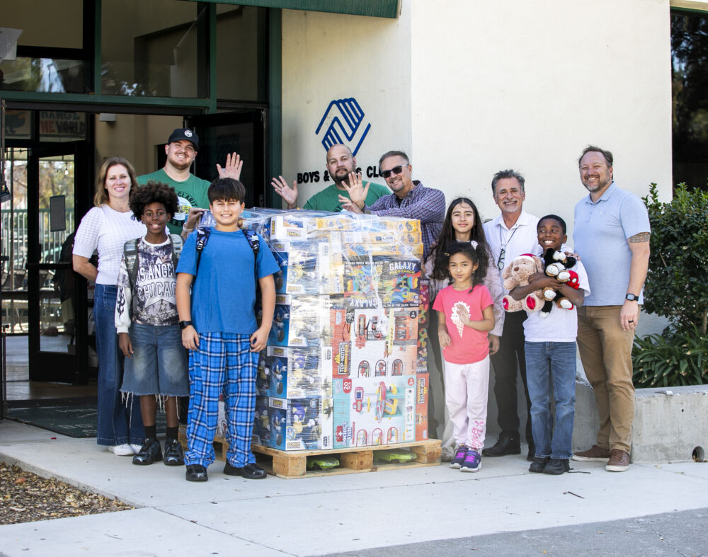 Members of Santa Clarita Studios and the Boys & Girls Club stand with a pallet of toys that were donated to the Santa Clarita Valley Boys & Girls Club-James T. Ventress Clubhouse in Newhall on Wednesday, Dec. 17, 2025. Habeba Mostafa/ The Signal