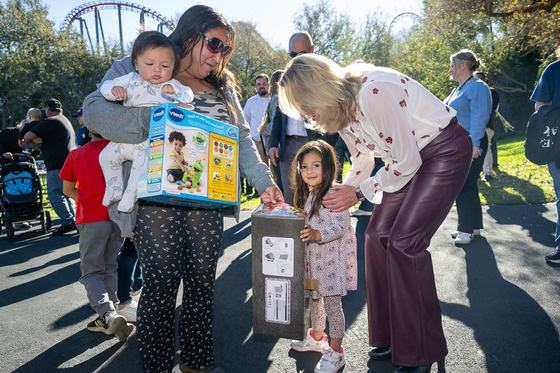 Supervisor Kathryn Barger greets a smiling young guest and her caregiver following the toy selection. Photo by Michael Owen Baker/L.A. County