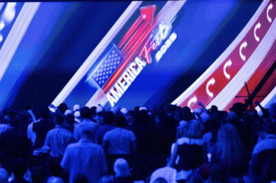 Groups of people enter Turning Point USA's AmericaFest in Phoenix on Dec. 21, 2025. Photo by John Fredricks.