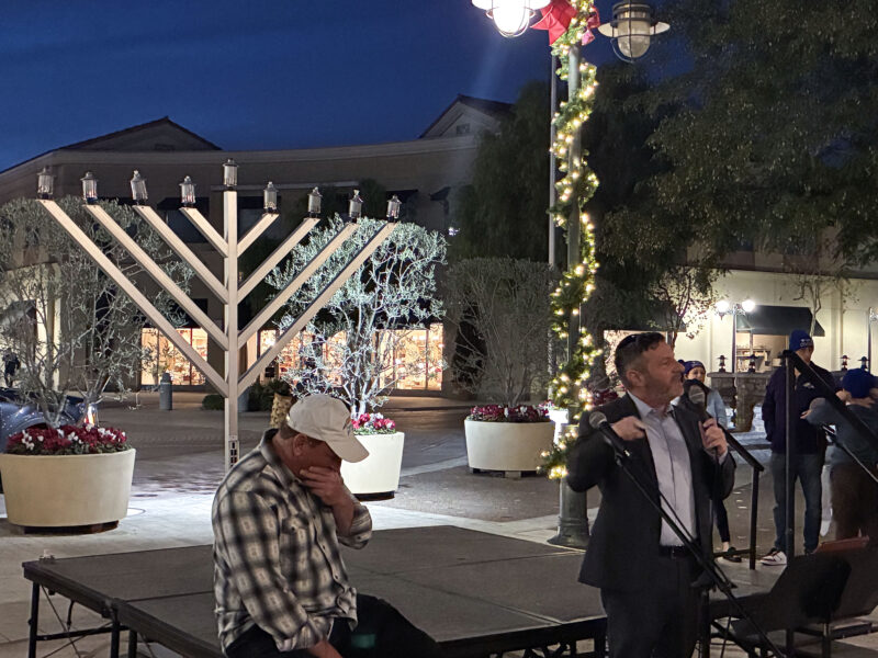 Rabbi Jay Siegel (R) speaks to the audience at the Hanukkah at the Mall celebration at Westfield Valencia Town Center in Valencia, Calif., Sunday, Dec. 21, 2025. Kamryn Martell/The Signal