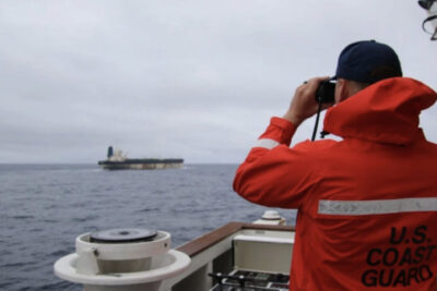 An undated photo uploaded by the U.S. European Command on Jan. 7, 2026, shows a U.S. Coast Guard official surveying a ship. Courtesy of US European Command.