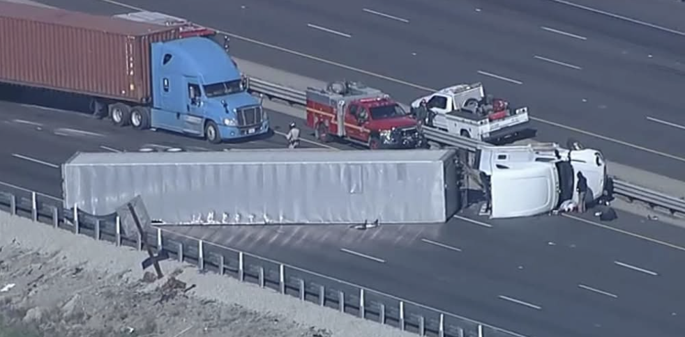 A semi-truck involved in a traffic collision lays on its side on the southbound lanes of Interstate 5 near Vista Del Lago on Thursday morning. Screenshot courtesy of ABC7.