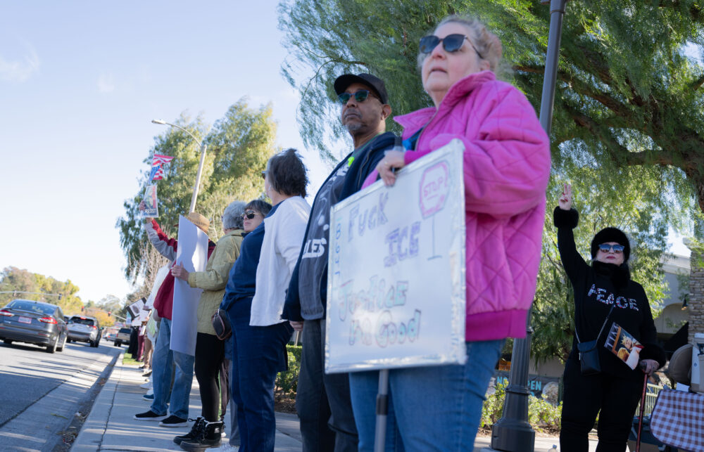 People hold up signs protesting the Trump administration on Saturday, Jan. 10, 2026 on Valencia. Katherine Quezada/The Signal