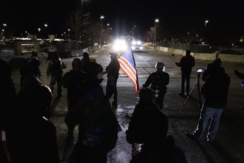 Protestors taunt federal officers with flags and microphones in front of the Bishop Henry Whipple Federal Building in Minneapolis on Jan. 11, 2026. Photo by John Fredricks.