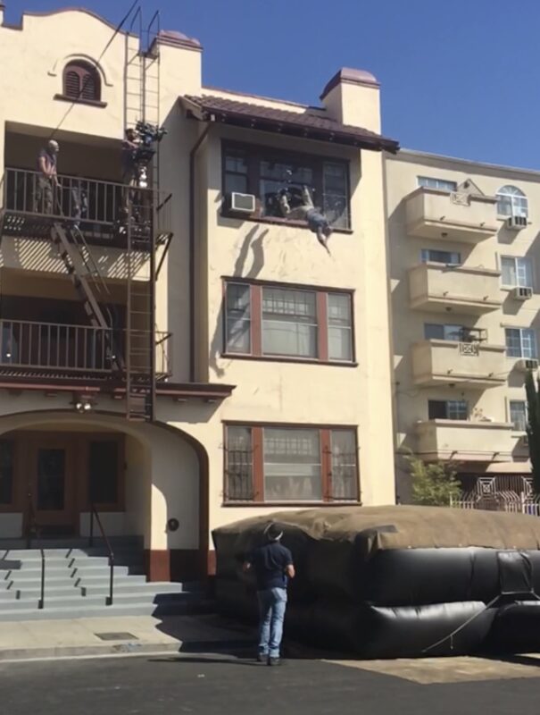 Dennis Keiffer jumps out of a window for the TV show “Snowfall” on location in downtown Los Angeles, 2019. Courtesy of Dennis Keiffer