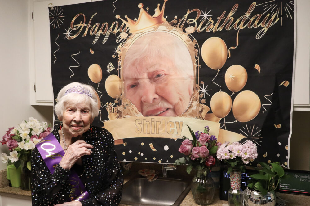 Shirley O'Connell poses with a birthday banner at her home at Atria Senior Living in Newhall, Calif., Wednesday, Jan. 14, 2026. Kamryn Martell/The Signal
