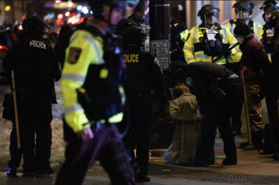 A protester against Immigration and Customs Enforcement operations is arrested by police officers in Minneapolis, Minn., on Jan. 9, 2026. Photo by John Fredricks.