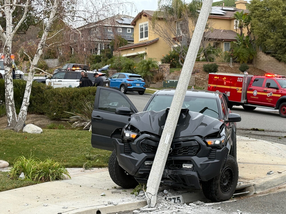 The driver of a Toyota Tacoma pickup was transported to the hospital Wednesday morning after suffering a medical emergency and striking two light poles in a Saugus residential neighborhood. Signal staff photo.