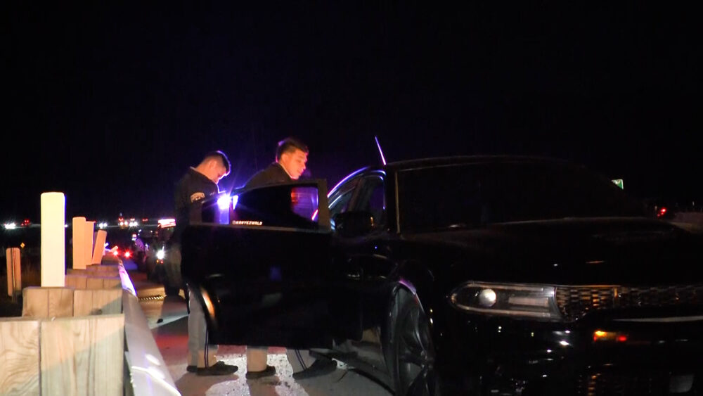 California Highway Patrol officers engage with one of the cars after the pursuit on State Route 14 near Soledad Canyon Road. Signal file photo.