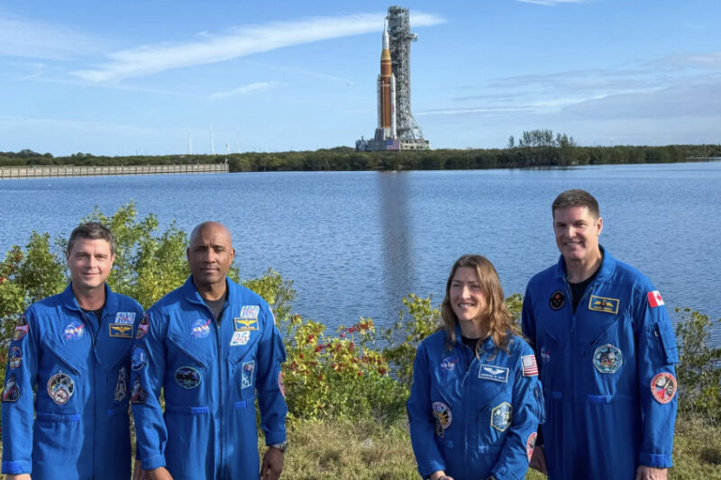 (L–R) NASA astronauts Reid Wiseman, Victor Glover, and Christina Koch, as well as Canadian Space Agency astronaut Jeremy Hansen stand in front of the Space Launch System rocket as it rolls out to the launch pad at Kennedy Space Center, Fla., on Jan. 17, 2026. Photo by T.J. Muscaro.