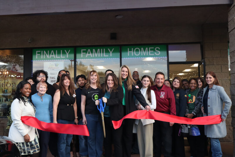 Christina Dronen (C, holding scissors) cuts the ribbon at the Finally Family Homes Oasis Resource Center ribbon cutting in Newhall, Calif., Tuesday, Jan. 27, 2026. Kamryn Martell/The Signal