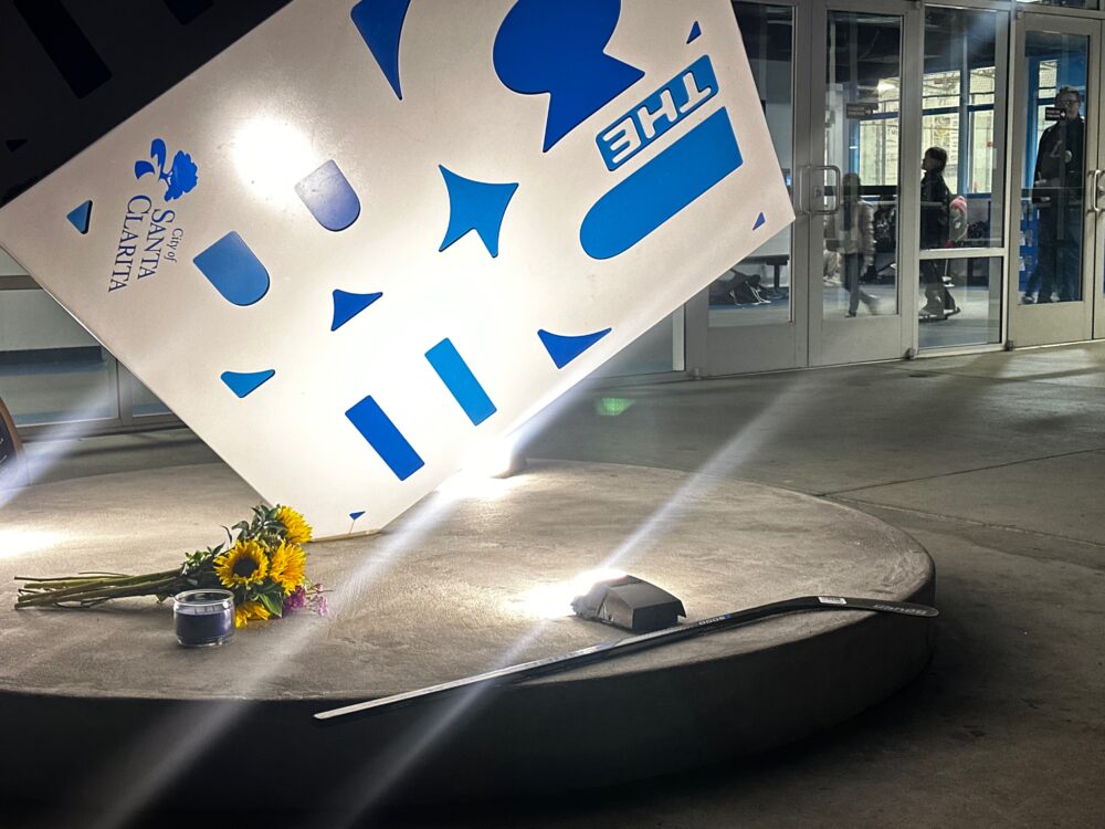 Flowers and a hockey stick were placed near the entrance of The Cube in Valencia after members of a girls hockey team were involved in a crash in Colorado that killed the father of one of the girls on Thursday, Jan. 29, 2026. Katherine Quezada/The Signal