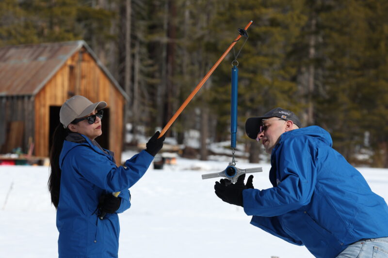 California Department of Water Resources (from right) Engineer Jacob Kollen, Hydrometerologist Angelique Fabbiani-Leon and Snow Survey and Water Supply Forecasting Unit Manager Andy Reising take measurements during the second media snow survey of the 2026 season at Phillips Station in the Sierra Nevada. The snow survey is held approximately 90 miles east of Sacramento off Highway 50 in El Dorado County. Photo taken January 30, 2026. 

