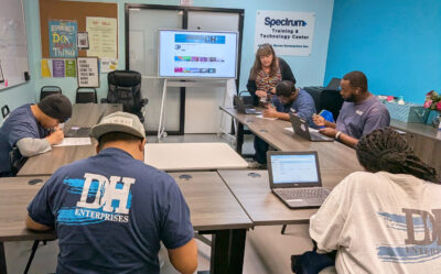 Employment Specialist Nancy Matherly assists Desert Haven consumers during a workforce training class. Courtesy photo.