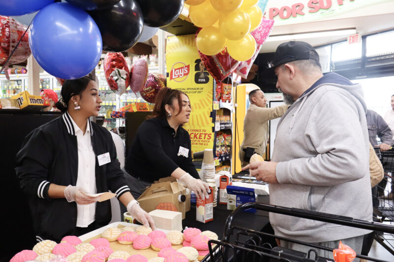 Lianka Roa (L) and Abigail Flores (R), Vallarta Supermarket workers, hand out conchas and cafe de olla at Conchas and Community with California Highway Patrol Newhall-area Office at Vallarta in Newhall, Tuesday, Feb. 10, 2026. Kamryn Martell/The Signal