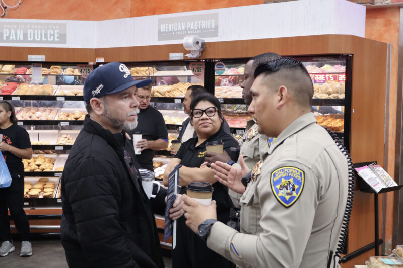 Israel Tovar talks to Officer Carlos Burgos-Lopez at Conchas and Community with California Highway Patrol Newhall-area Office at Vallarta Supermarket in Newhall, Tuesday, Feb. 10, 2026. Kamryn Martell/The Signal