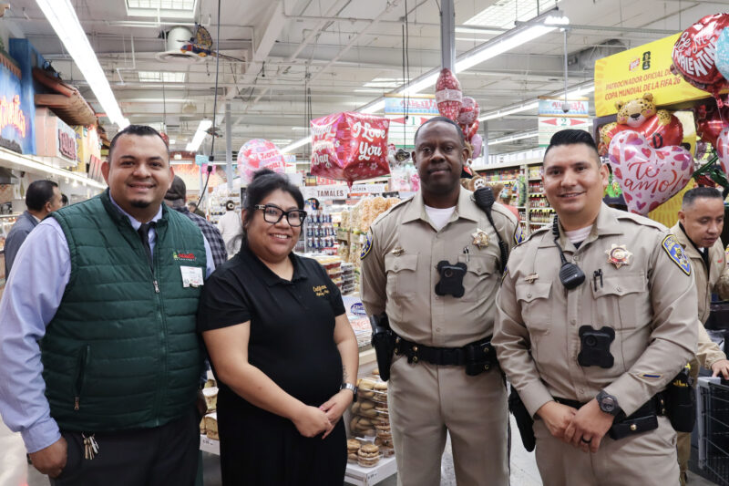 Vallarta Supermarkets workers and California Highway Patrol Newhall-area officers smile for the camera at Conchas and Community at Vallarta in Newhall, Tuesday, Feb. 10, 2026. Kamryn Martell/The Signal