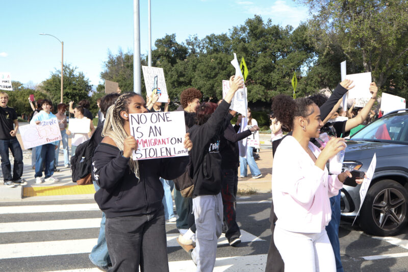 West Ranch High School students hold signs while crossing the street at an anti-ICE walk out and protest at the intersection of The Old Road and Valencia Boulevard in Stevenson Ranch, Thursday, Feb. 12, 2026. Kamryn Martell/The Signal