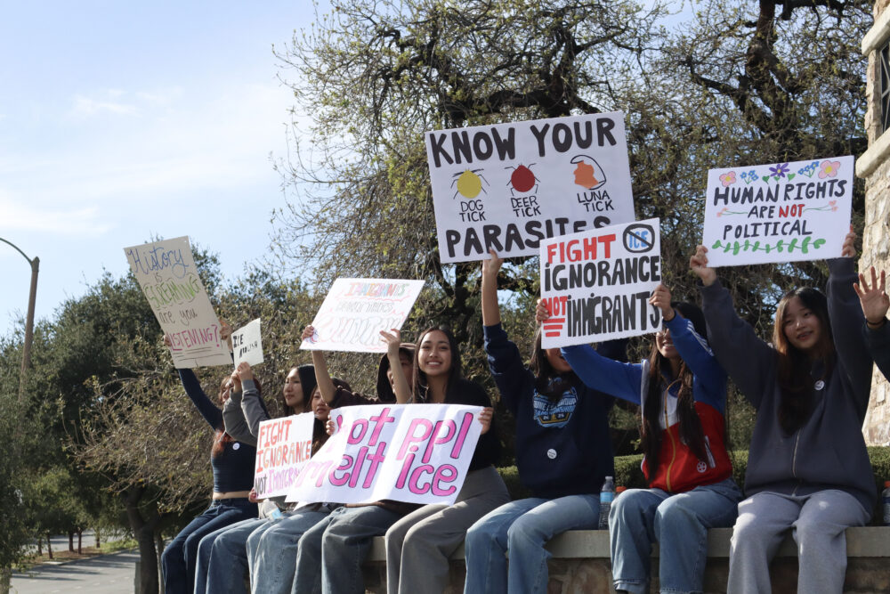 West Ranch High School students hold signs at an anti-ICE walk out and protest at the intersection of The Old Road and Valencia Boulevard in Stevenson Ranch, Thursday, Feb. 12, 2026. Kamryn Martell/The Signal