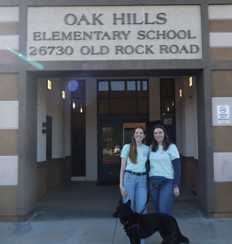 Tara Bennett (L), Foxy (C) and Gina Murphy (R) smile for a photo at Oak Hills Elementary School, Tuesday, Feb. 24, 2026. Kamryn Martell/The Signal