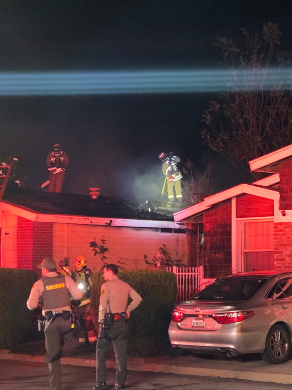 Los Angeles County Fire Department personnel vent out a home after a structure fire on the 31900 block of Quartz Lane in Castaic. Lydia Schneider/The Signal