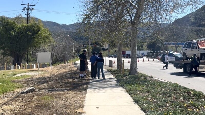 People stand on the sideway while the car gets loaded on a tow truck bed after a fatal collision on Newhall Avenue and Sierra Highway, Sunday, March 1, 2026. Signal Staff/The Signal