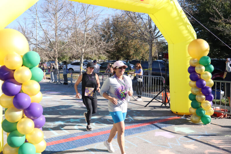 Participants cross the finish line at JCI Santa Clarita's 16th annual "Mardi Gras Madness" 5K and 10K at Valencia Town Center, Sunday, March 1, 2026. Kamryn Martell/The Signal