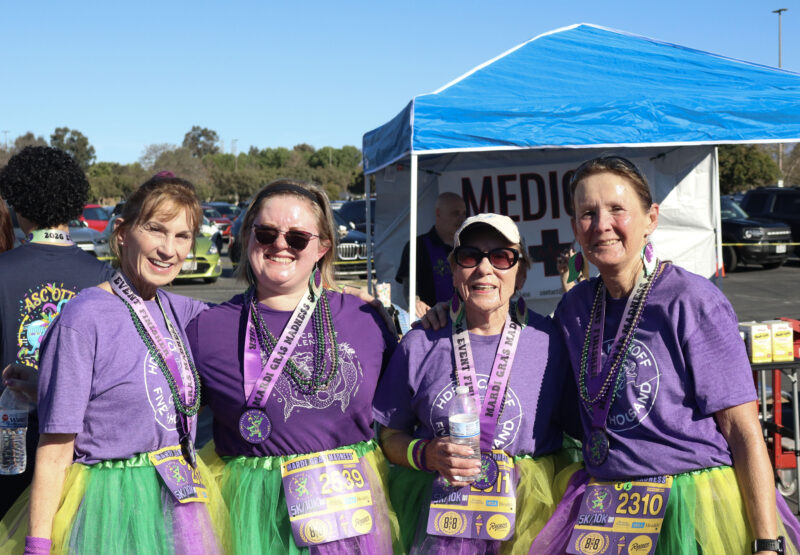 The Wells Family smile for the camera in their Mardi Gras-themed outfits at JCI Santa Clarita's 16th annual "Mardi Gras Madness" 5K and 10K at Valencia Town Center, Sunday, March 1, 2026. Kamryn Martell/The Signal