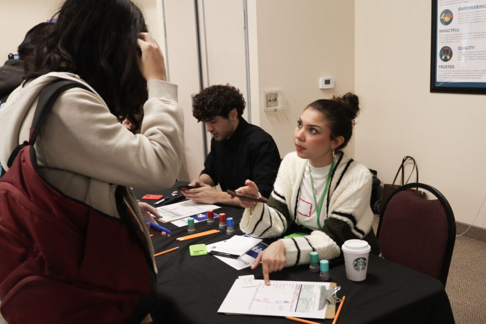 Juliette Jamjian helps a Bowman High School student at the "bank" at the JCI Santa Clarita's "Get Real: Adulting 101" financial literacy event at Child & Family Center in Canyon Country, Calif., Wednesday, March 4, 2026. Kamryn Martell/The Signal