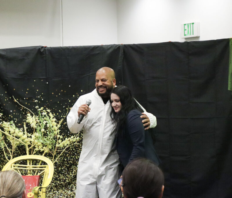Steven Binns (left), author of "Buzz to the Stars: The Bee Ship Adventure," and Armine Gevorkyan (right), illustrator of "Buzz to the Stars: The Bee Ship Adventure" hug at the 5th annual Hope Theatre Arts event at the Canyon Country Jo Anne Darcy Library in Canyon Country, Calif., Sunday, March 8, 2026. Kamryn Martell/The Signal