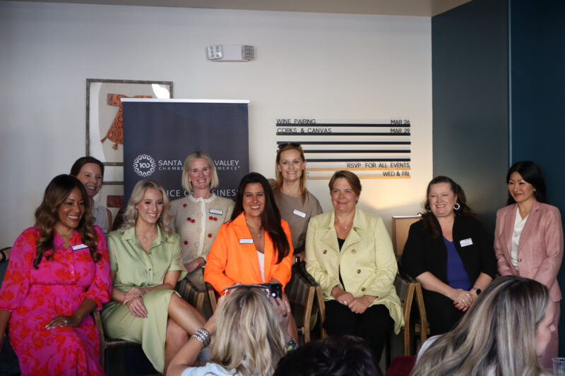 The InfluenceHER panel and attendees smile for a photo at the Santa Clarita Valley Chamber of Commerce's "InfluenceHER: Boardroom Ready" event at Kindred Spirits Wine Bar in Valencia, Calif., Tuesday, March 10, 2026. Kamryn Martell/The Signal