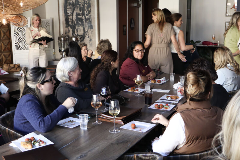 Attendees listen and enjoy some food at the Santa Clarita Valley Chamber of Commerce's "InfluenceHER: Boardroom Ready" event at Kindred Spirits Wine Bar in Valencia, Calif., Tuesday, March 10, 2026. Kamryn Martell/The Signal